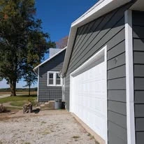 Close view of grey exterior siding, porch, and white trim