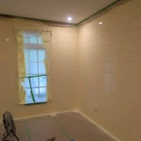 Interior room with painted walls, white trim, and plank flooring