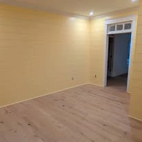 Interior room with painted walls, white trim, and plank flooring
