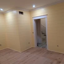Interior room with painted walls, white trim, and plank flooring