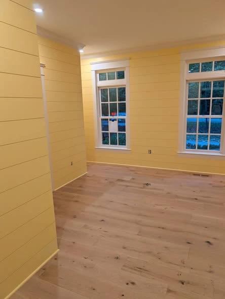 Interior room with painted walls, white trim, and plank flooring