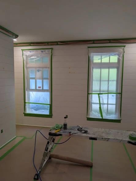 Interior room with painted walls, white trim, and plank flooring