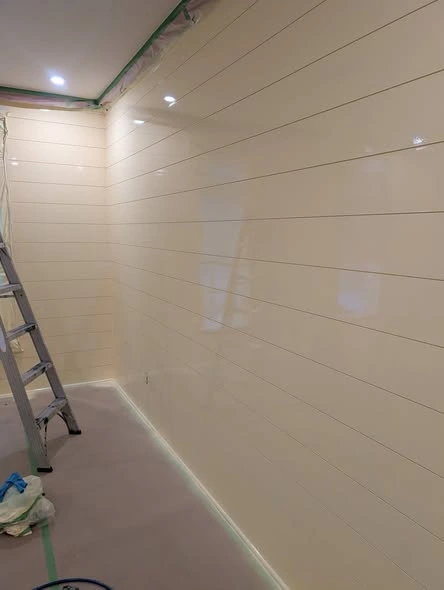 Interior room with painted walls, white trim, and plank flooring