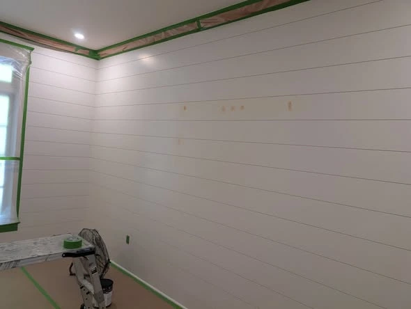 Interior room with painted walls, white trim, and plank flooring