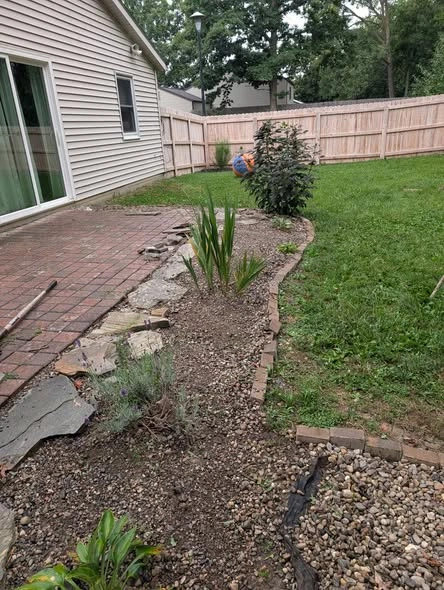 Paver patio and planting beds beside a home
