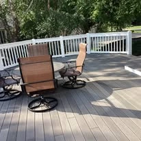 Outdoor deck with grey surface boards and white railing