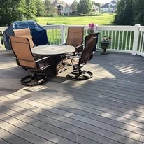 Outdoor deck with grey surface boards and white railing