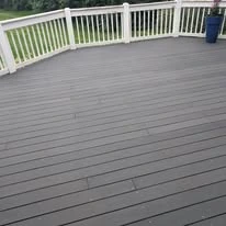 Outdoor deck with grey surface boards and white railing