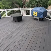 Outdoor deck with grey surface boards and white railing