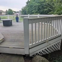 Outdoor deck with grey surface boards and white railing