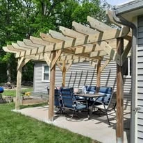 Wooden pergola beside a home