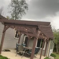 Wooden pergola structure alongside a home